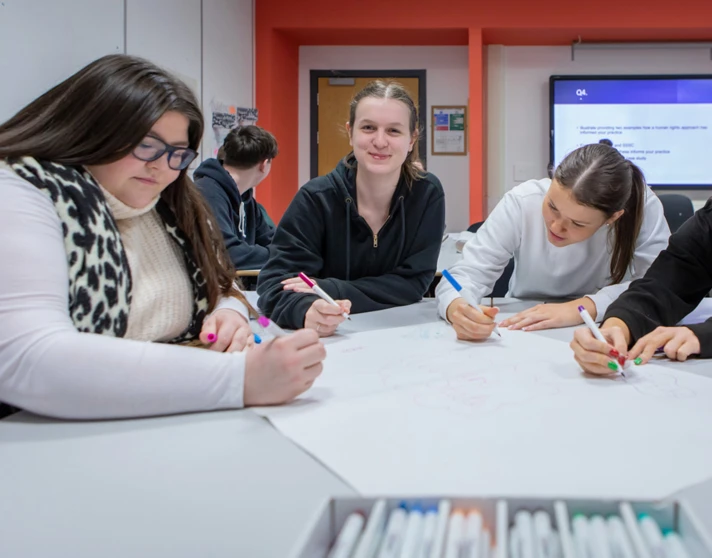 A vibrant snapshot of Glasgow Kelvin College students working together, sharing thoughts and smiles in a supportive classroom setting. A vibrant snapshot of Glasgow Kelvin College students working together, sharing thoughts and smiles in a supportive classroom setting.